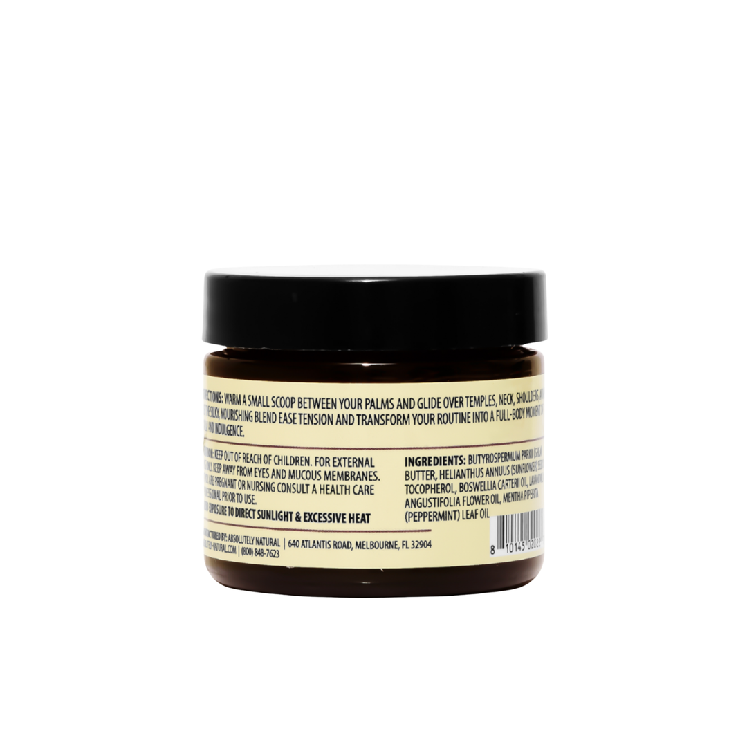 Back view of Kinsley Oils Massage Butter in an amber jar with a black lid, showing the product directions, ingredients, and safety information on a cream-colored label against a white background.