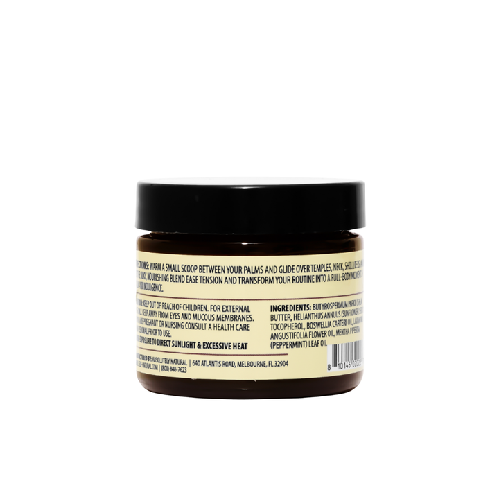 Back view of Kinsley Oils Massage Butter in an amber jar with a black lid, showing the product directions, ingredients, and safety information on a cream-colored label against a white background.