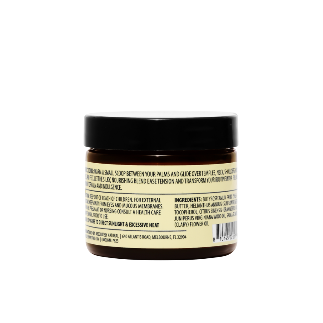 Back view of Kinsley Oils Massage Butter in an amber jar with a black lid, showing the product directions, ingredients, and safety information on a cream-colored label against a white background.