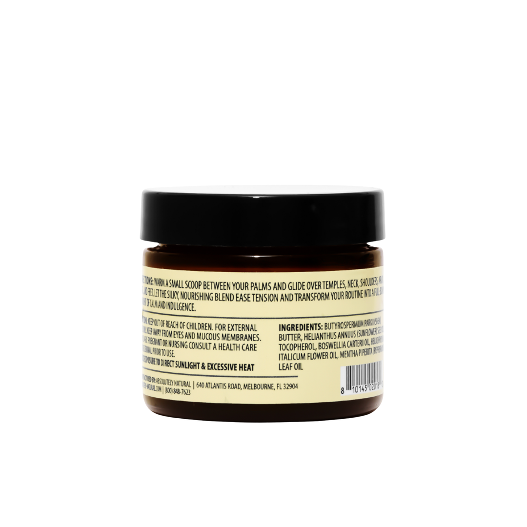 Back view of Kinsley Oils Massage Butter in an amber jar with a black lid, showing the product directions, ingredients, and safety information on a cream-colored label against a white background.